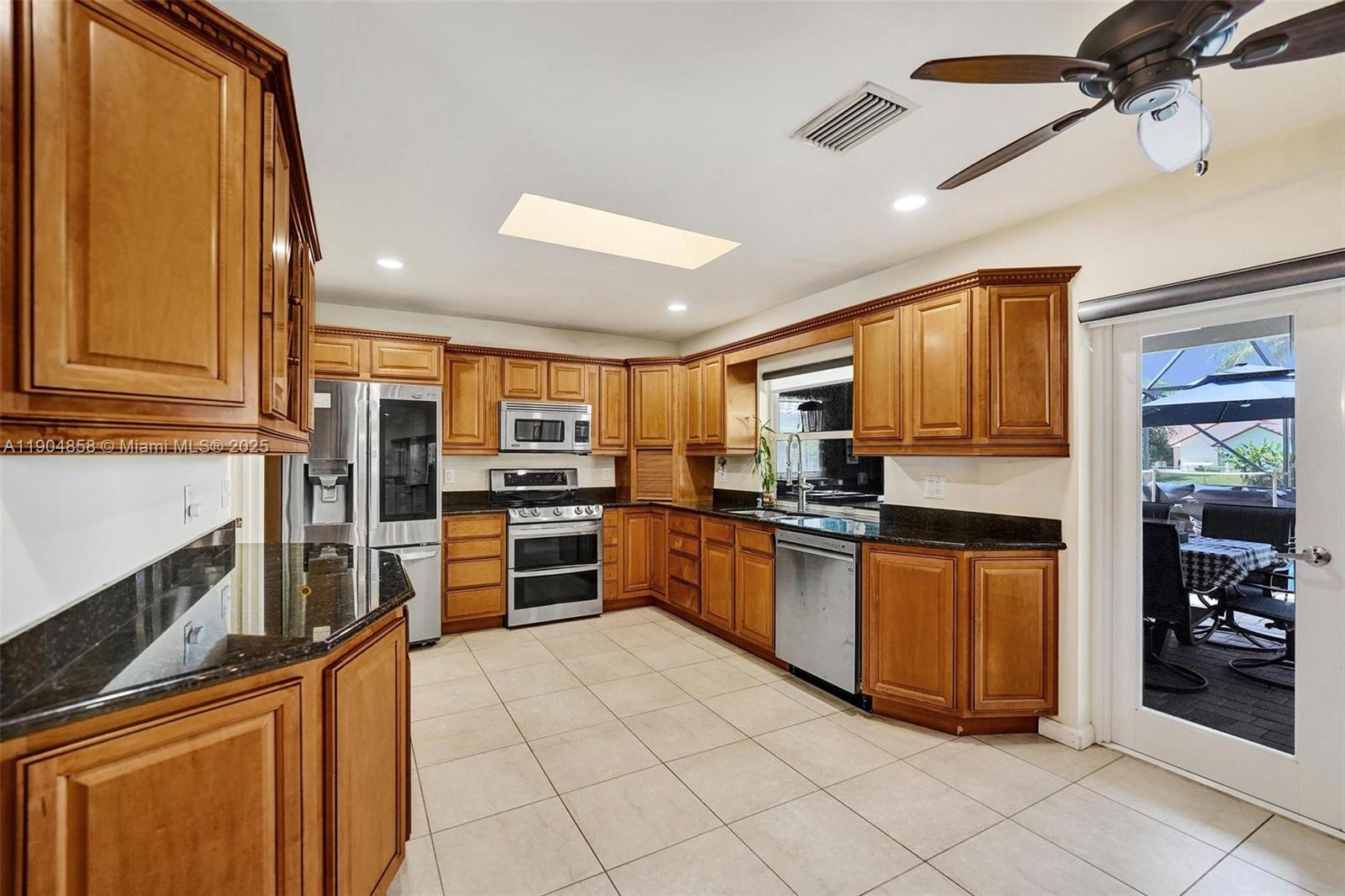 1501 Northwest 99th Avenue Plantation, FL 33322 - Photo 10 of 45 a kitchen with stainless steel appliances granite countertop a refrigerator and a stove top oven