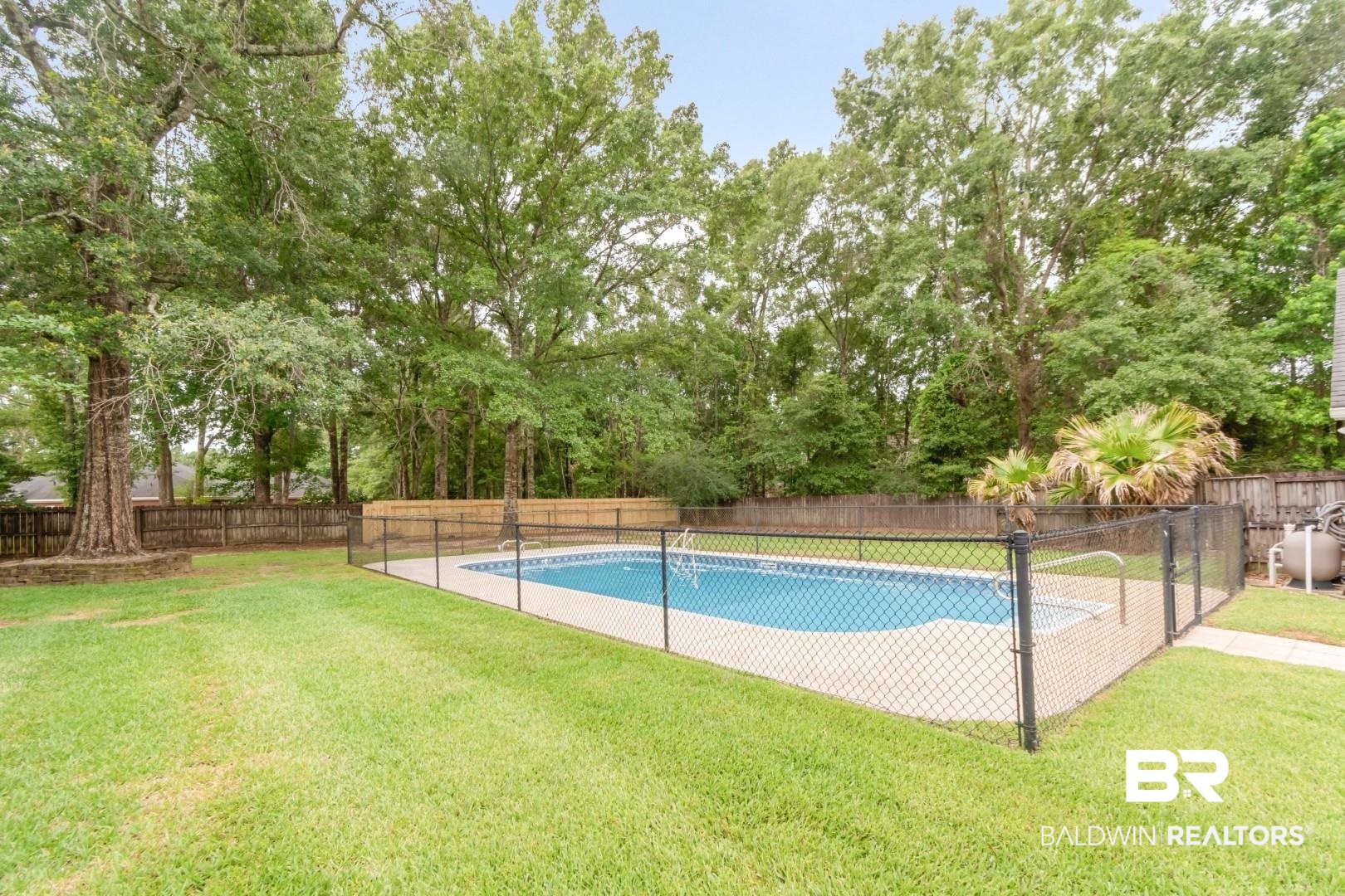 10691 Hunters Ridge Drive Mobile, AL 36695 - Photo 33 of 37 Outdoor swimming pool area featuring a perimeter fence, surrounding patio, and a spacious grass lawn