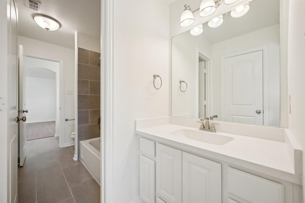2029 Temperate Drive Allen, TX 75013 - Photo 26 of 40 a bathroom with a sink vanity and a mirror