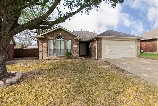 a view of a house with a yard and garage