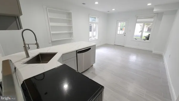 a kitchen with a sink a table and chairs