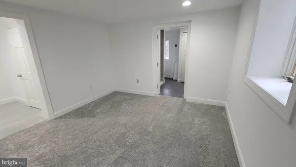 a bathroom with a toilet and a mirror