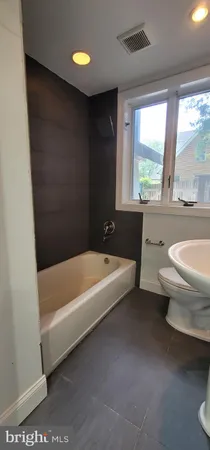 a view of bathroom with a sink and a window