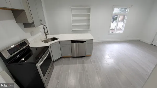 a kitchen with a wooden floor and a sink