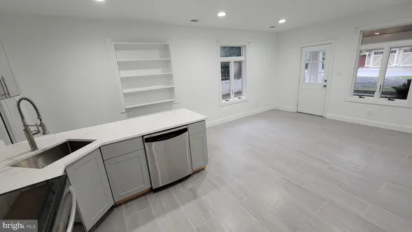 a view of a kitchen with a sink and cabinets