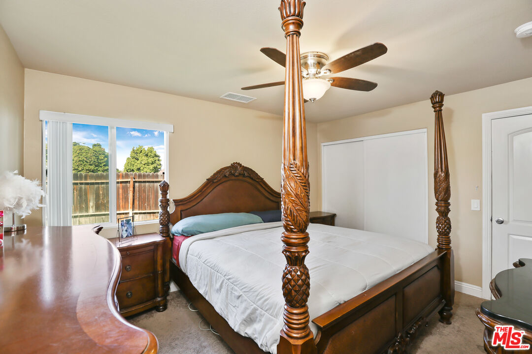 9225 Flax Place Riverside, CA 92503 - Photo 14 of 35 a bedroom with a bed and wooden floor