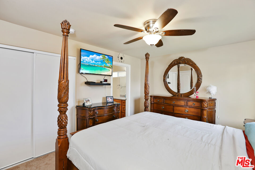 9225 Flax Place Riverside, CA 92503 - Photo 15 of 35 a bedroom with a bed and a chandelier