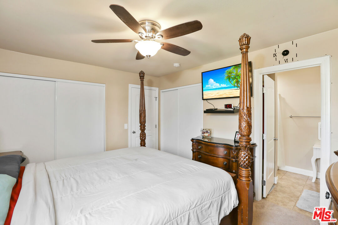 9225 Flax Place Riverside, CA 92503 - Photo 18 of 35 a bedroom with a bed and a chandelier