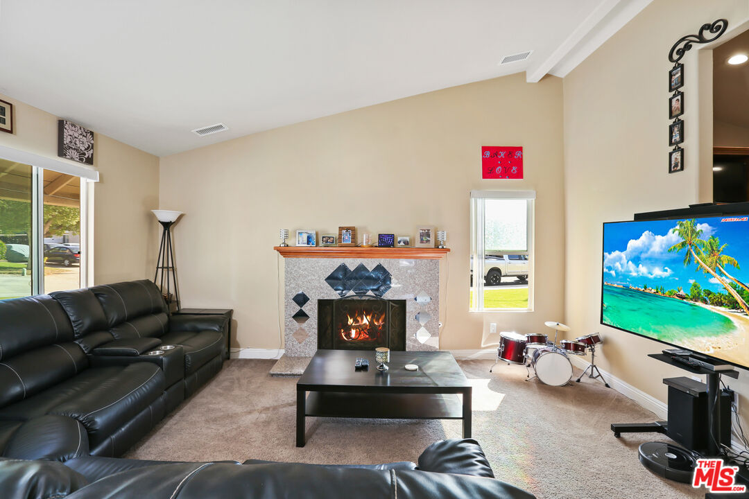 9225 Flax Place Riverside, CA 92503 - Photo 3 of 35 a living room with furniture a rug and a flat screen tv