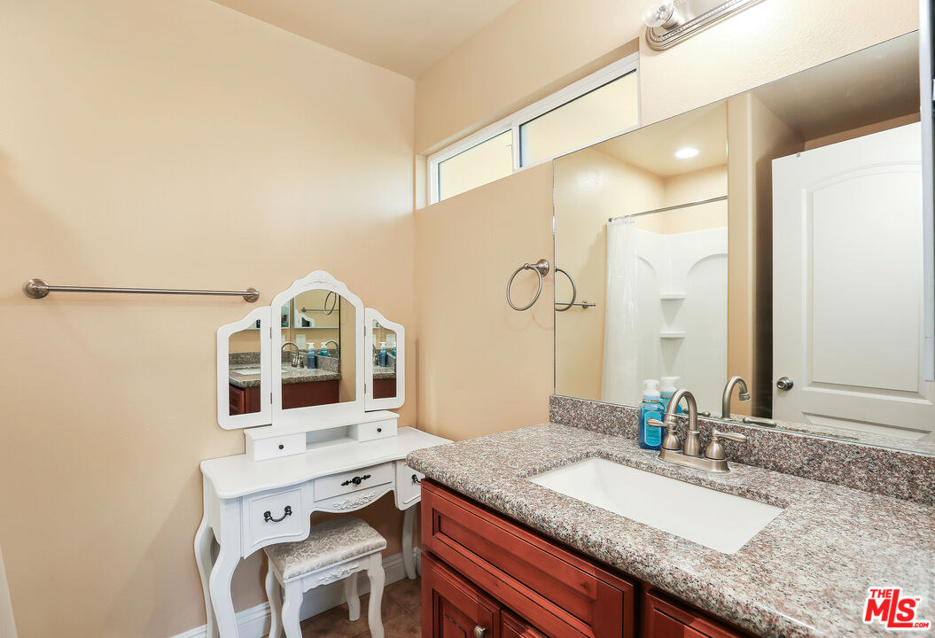 9225 Flax Place Riverside, CA 92503 - Photo 22 of 35 a bathroom with a granite countertop sink mirror and double
