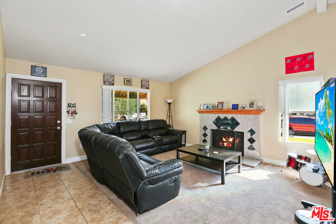 9225 Flax Place Riverside, CA 92503 - Photo 5 of 35 a living room with furniture a baby crib and a couch
