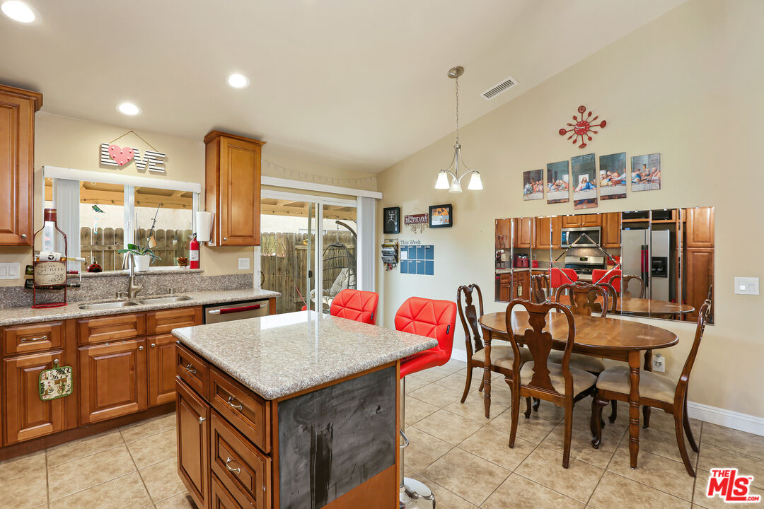 9225 Flax Place Riverside, CA 92503 - Photo 10 of 35 a view of a kitchen and dining table