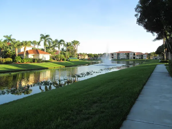 a view of a lake with houses in back