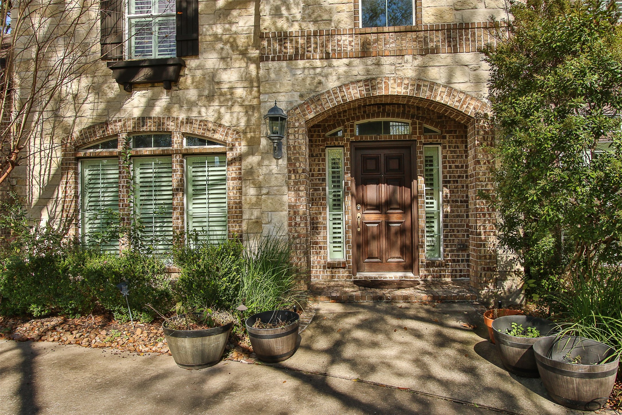11722 Spriggs Way Houston, TX 77024 - Photo 4 of 49 Inviting front porch/alcove and privacy with shutters for both sidelights