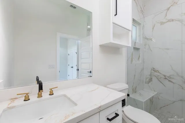 a bathroom with a sink toilet and shower