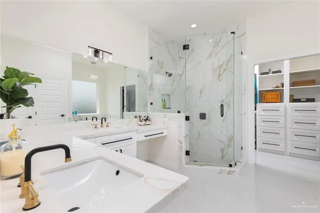 a bathroom with a double vanity sink mirror and shower
