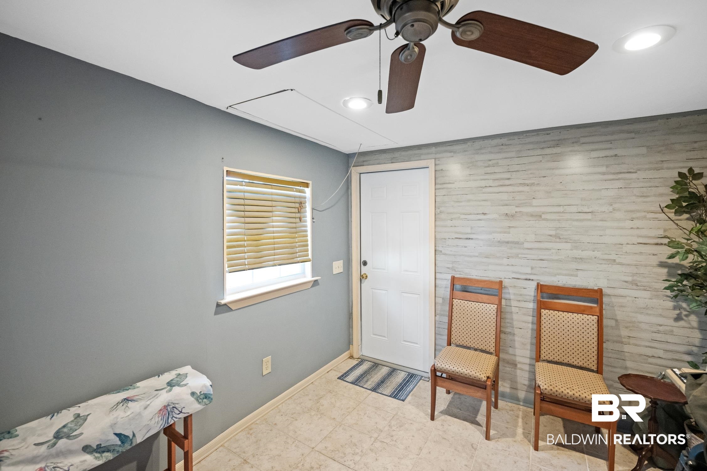 183 Defuniak Loop Lillian, AL 36549 - Photo 25 of 46 Living area featuring an accent wall, wooden walls, ceiling fan, baseboards, and recessed lighting