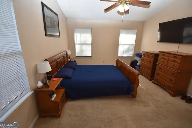 a bedroom with a bed and flat screen tv