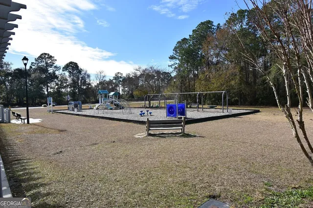 a park with large trees and a bench