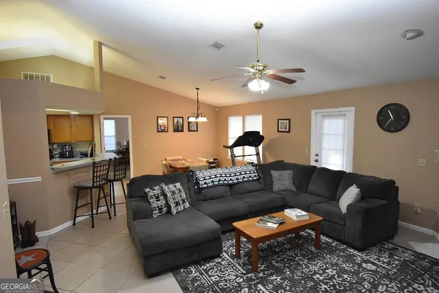 a living room with furniture ceiling fan and a rug