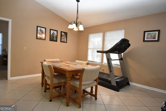 a view of a dining room with furniture and chandelier