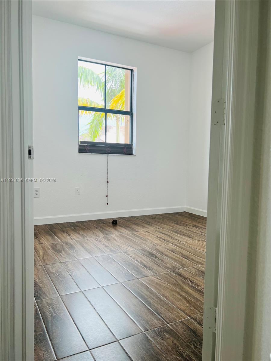 11219 Southwest 234 Terrace, Unit 11219 Homestead, FL 33032 - Photo 14 of 16 a view of a room that has a window in it