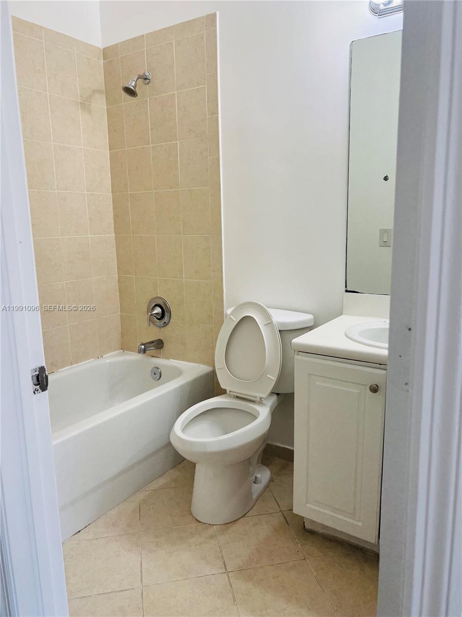 11219 Southwest 234 Terrace, Unit 11219 Homestead, FL 33032 - Photo 8 of 16 a white toilet sitting next to a bathroom sink