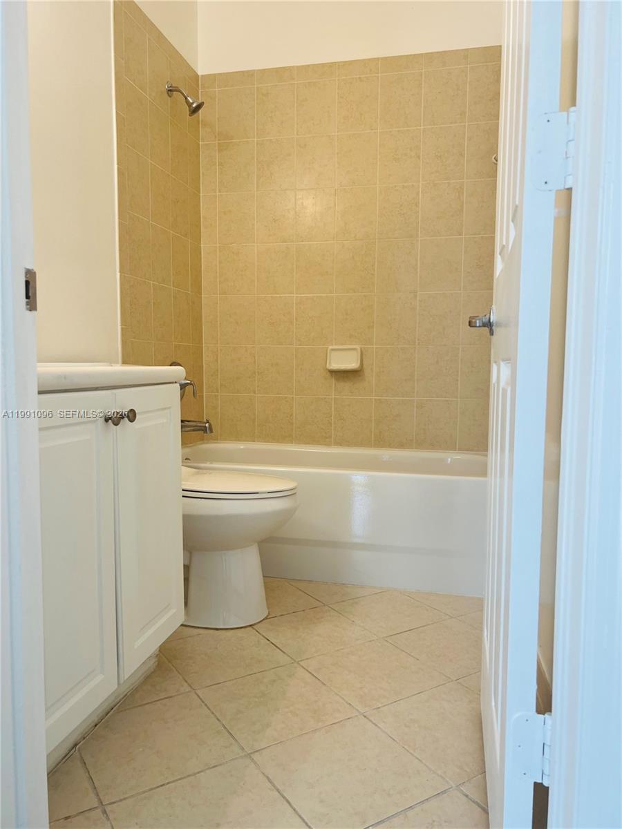 11219 Southwest 234 Terrace, Unit 11219 Homestead, FL 33032 - Photo 9 of 16 a bathroom with a toilet and shower