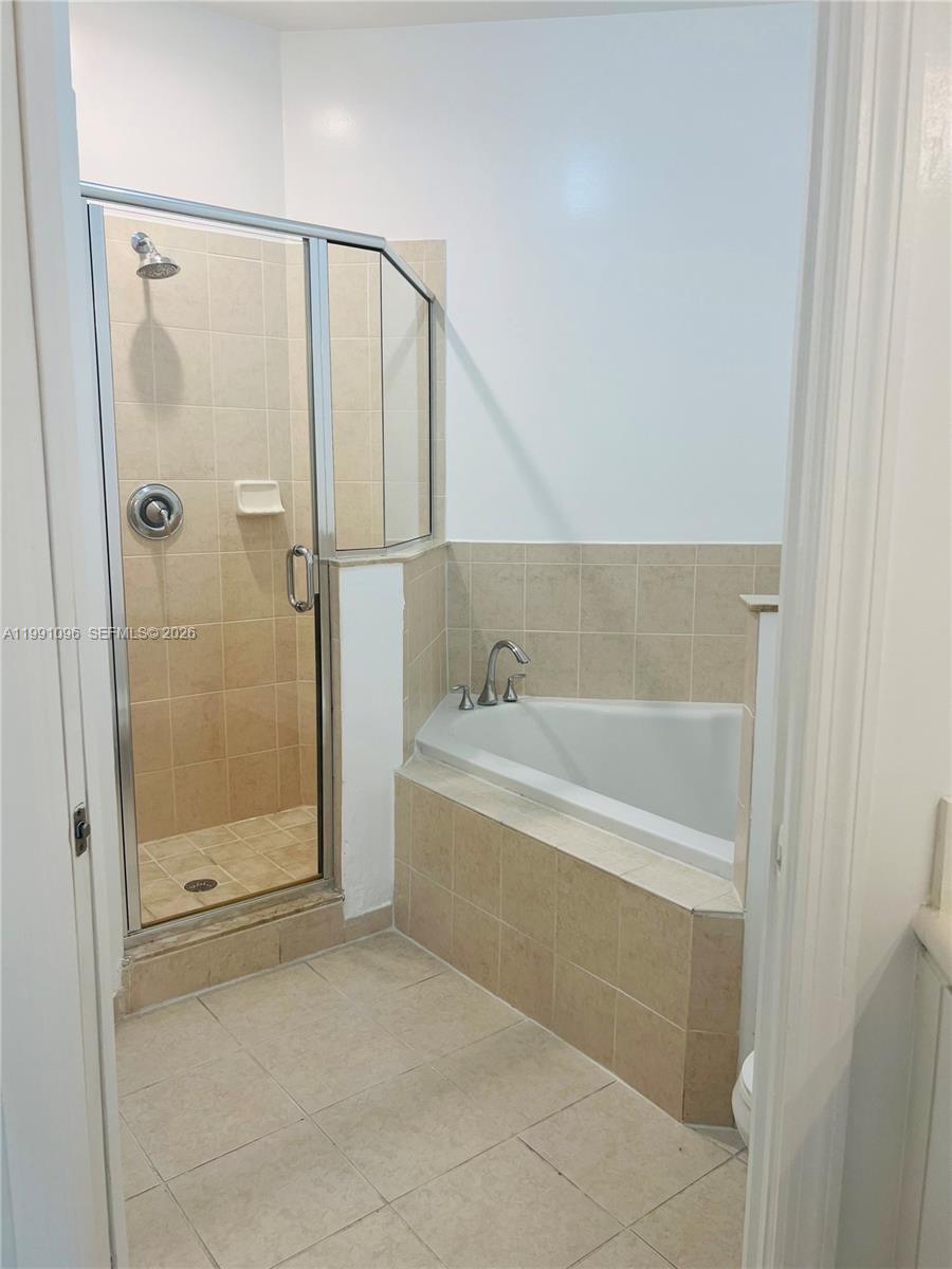 11219 Southwest 234 Terrace, Unit 11219 Homestead, FL 33032 - Photo 10 of 16 a spacious bathroom with a bathtub and shower