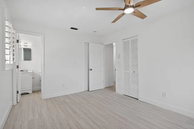 a view of a room with a hardwood and a ceiling fan