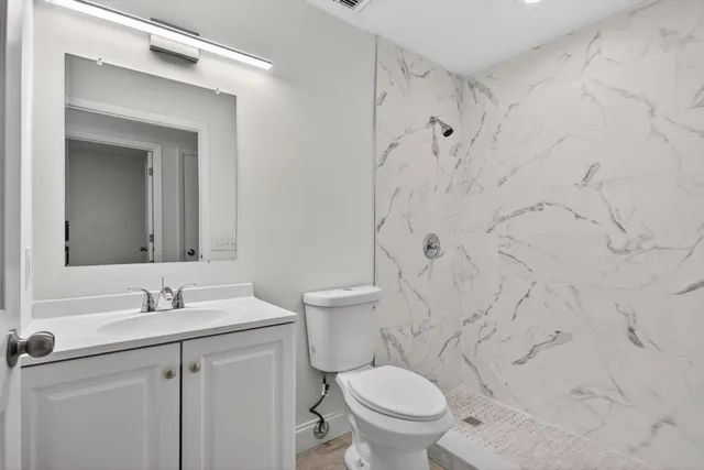 a bathroom with a sink toilet and shower