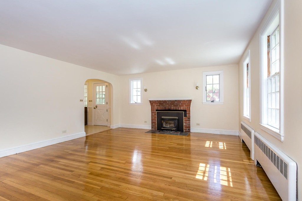 20 Brooksweld Road Canton, MA 02021 - Photo 3 of 22 a view of empty room with wooden floor and fireplace