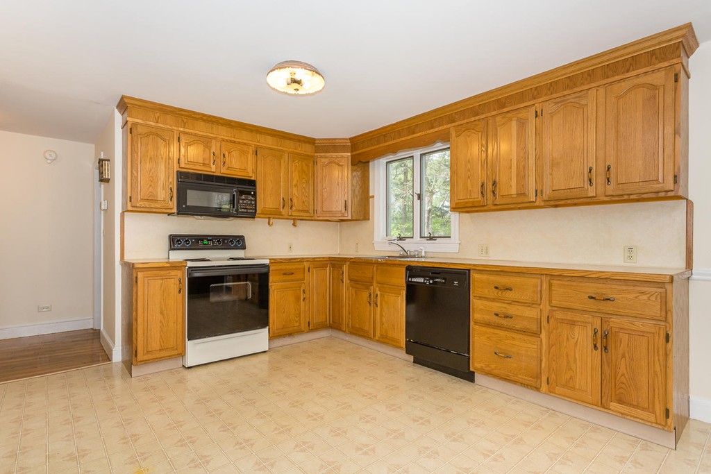 20 Brooksweld Road Canton, MA 02021 - Photo 7 of 22 a kitchen with stainless steel appliances granite countertop a stove top oven a sink dishwasher and a microwave oven with cabinets