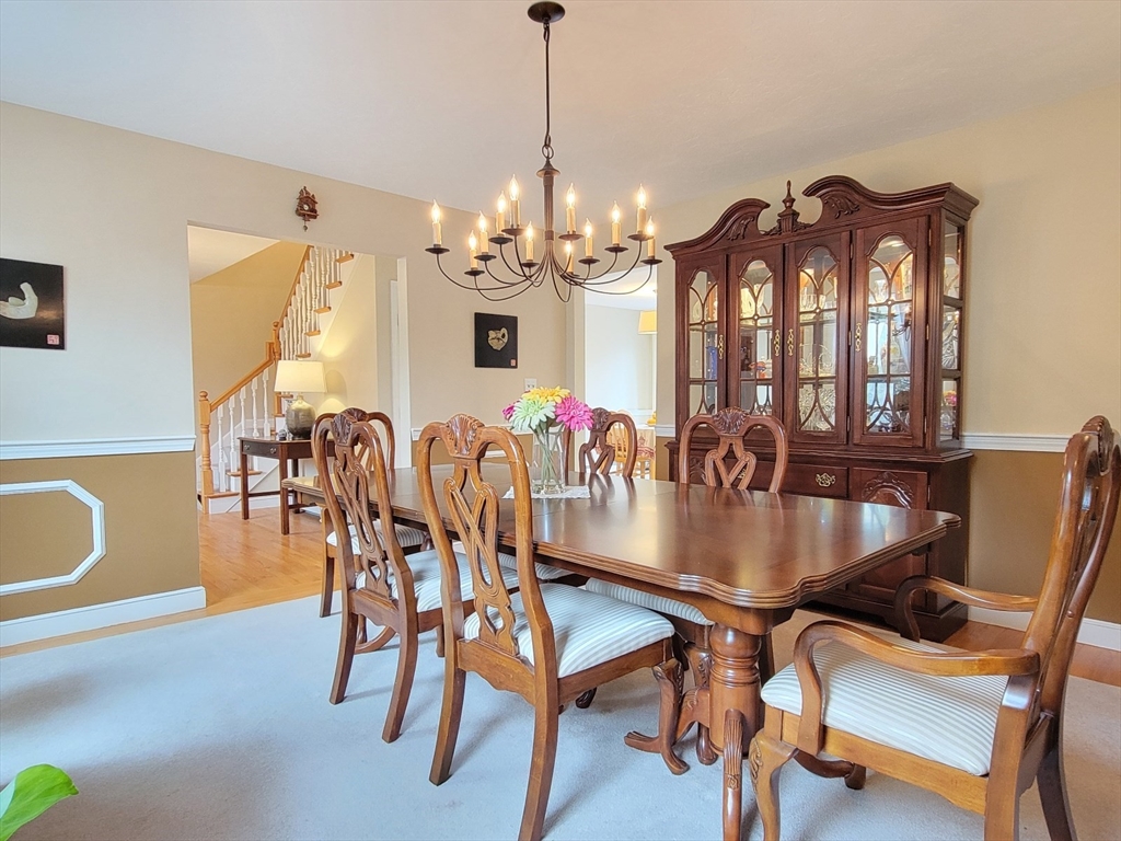 11 Femia Road Ashland, MA 01721 - Photo 14 of 42 a dining room with furniture a chandelier and wooden floor