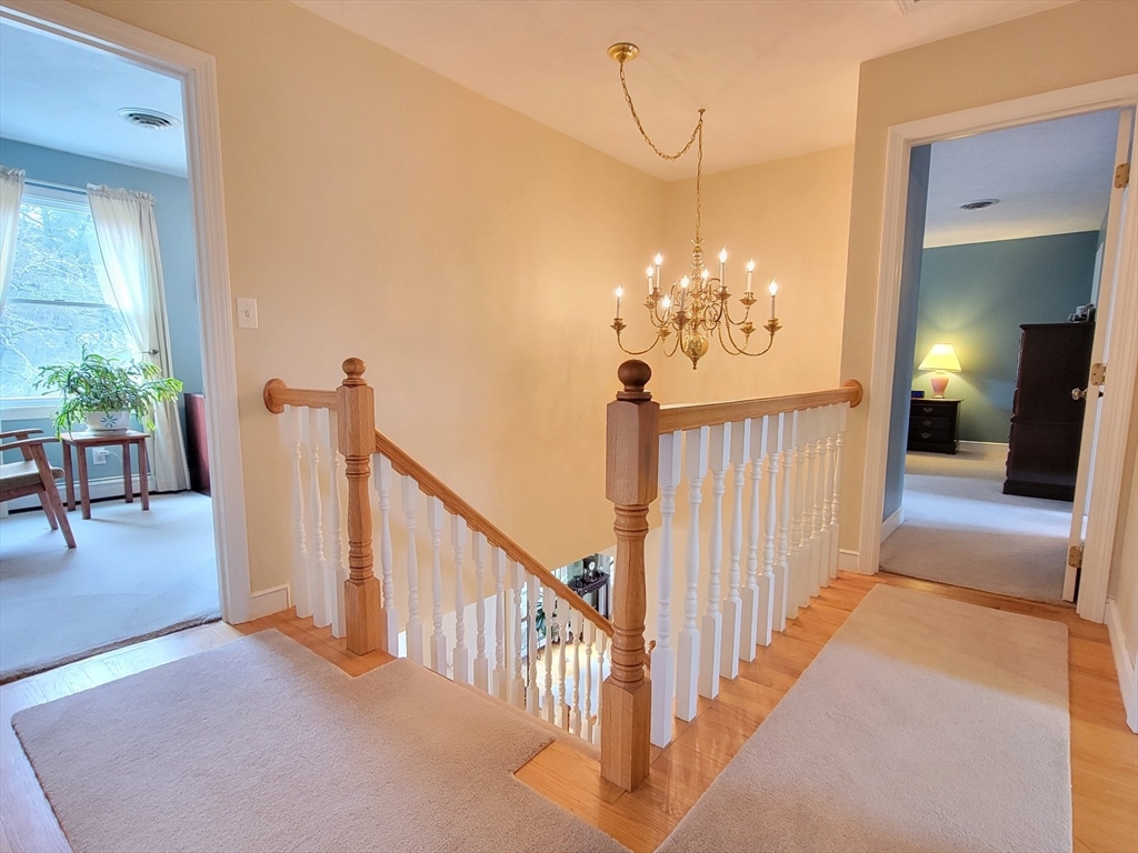 11 Femia Road Ashland, MA 01721 - Photo 26 of 42 a view of a chandelier in hallway with wooden floor