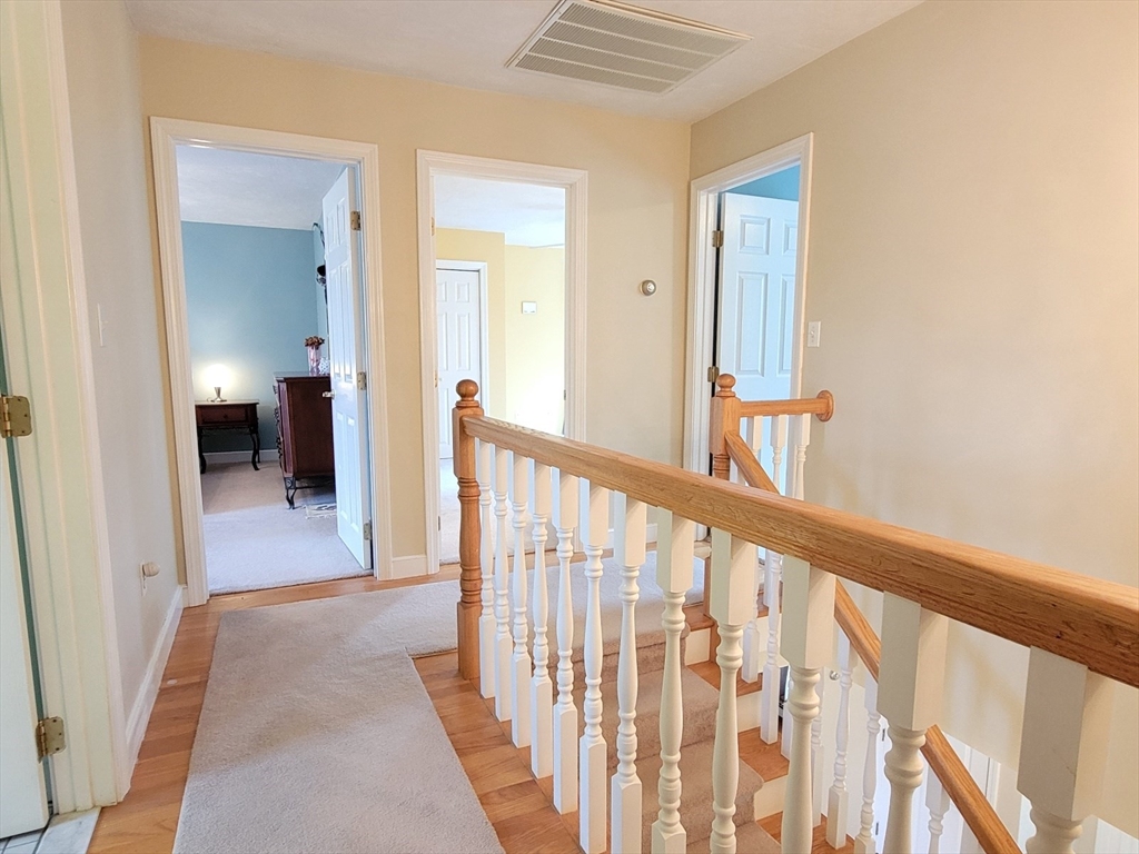 11 Femia Road Ashland, MA 01721 - Photo 29 of 42 a view of a hallway with wooden floor and a bathroom