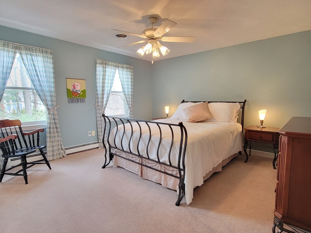 11 Femia Road Ashland, MA 01721 - Photo 30 of 42 a spacious bedroom with a bed and a chandelier