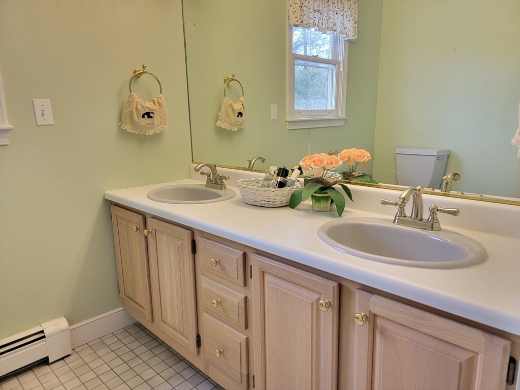 11 Femia Road Ashland, MA 01721 - Photo 32 of 42 a bathroom with a double vanity sink and a mirror