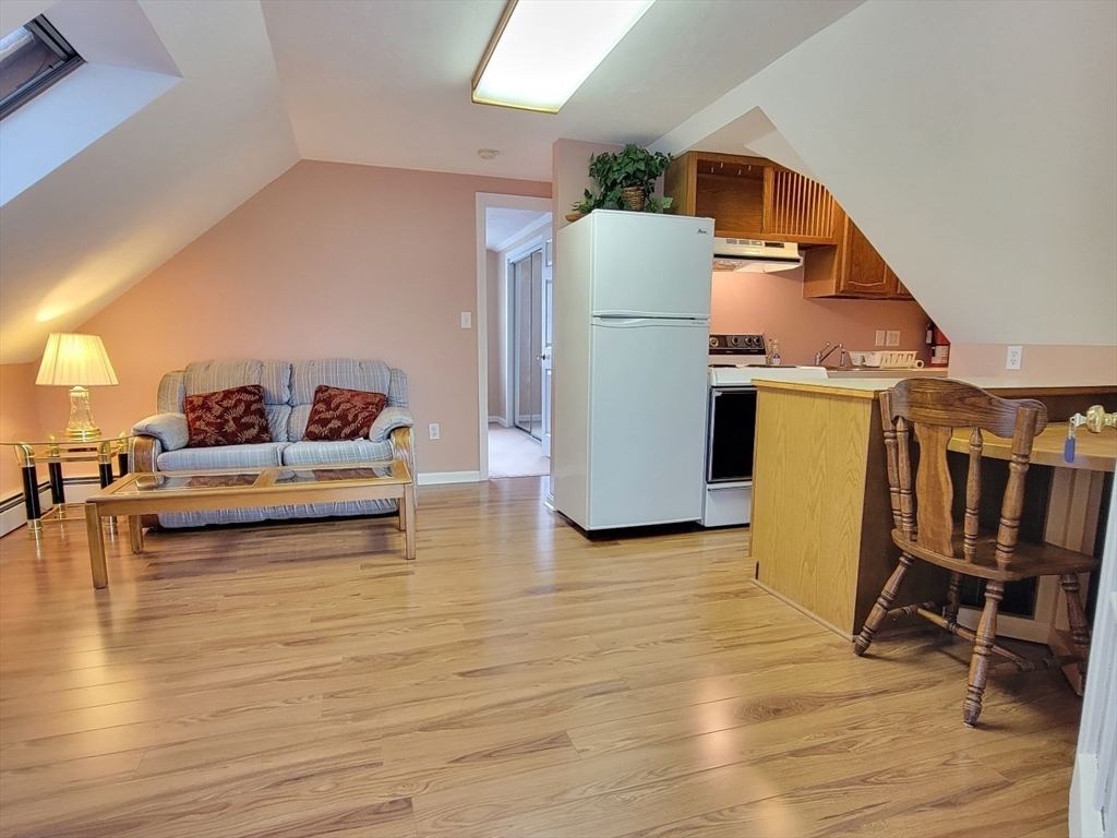 11 Femia Road Ashland, MA 01721 - Photo 37 of 42 a view of a livingroom with furniture and a kitchen view