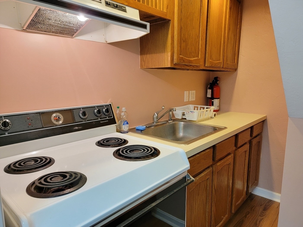11 Femia Road Ashland, MA 01721 - Photo 39 of 42 a kitchen with a sink a stove and cabinets