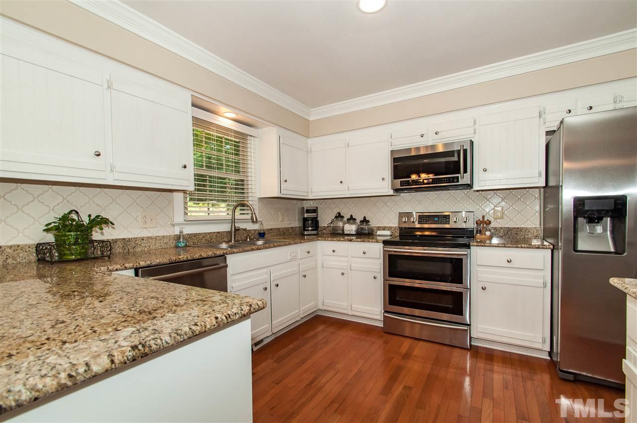 a kitchen with a stove a sink and a microwave