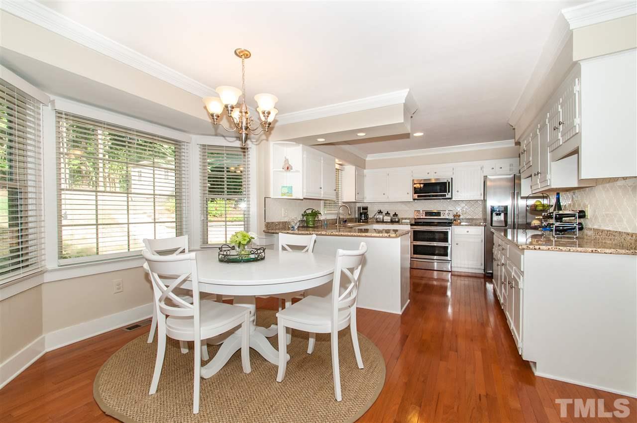 11905 Deer Run Raleigh, NC 27614 - Photo 11 of 25 a view of a dining room with furniture large window and wooden floor