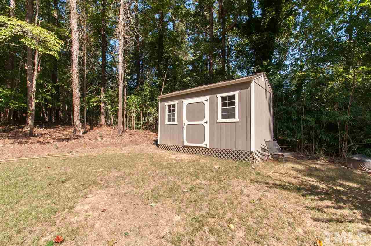 11905 Deer Run Raleigh, NC 27614 - Photo 18 of 25 a backyard of a house with large trees and covered with tall trees