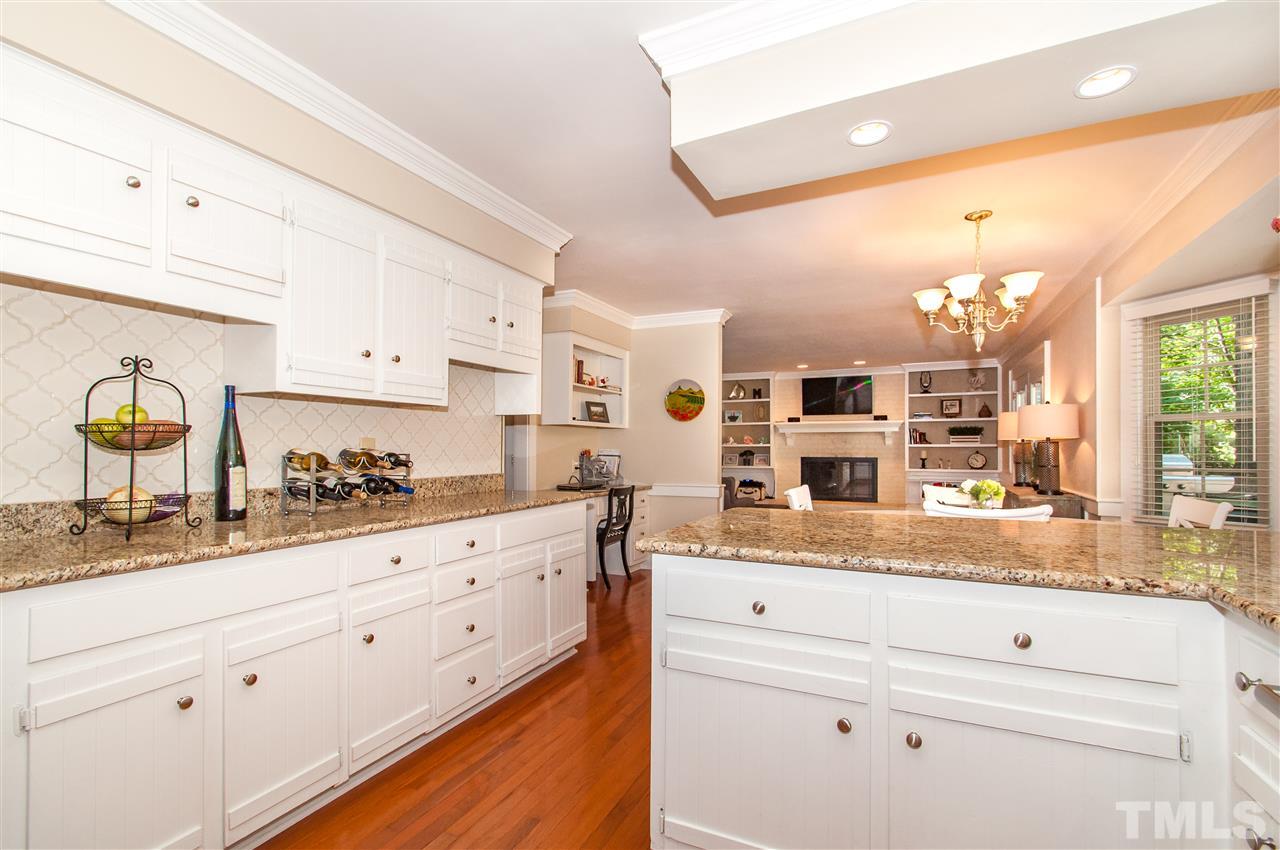 11905 Deer Run Raleigh, NC 27614 - Photo 4 of 25 a kitchen with granite countertop white cabinets and window