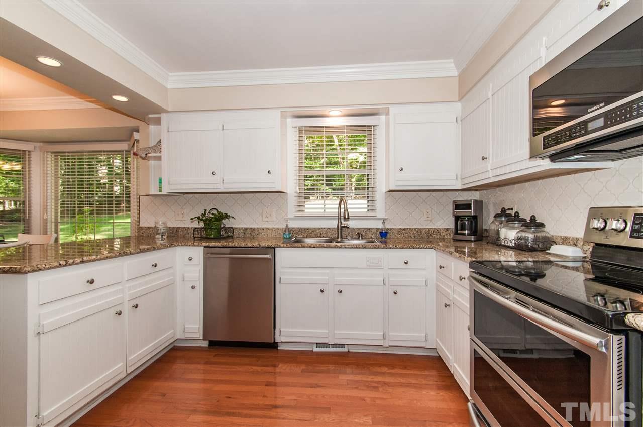 11905 Deer Run Raleigh, NC 27614 - Photo 5 of 25 a kitchen with granite countertop white cabinets and appliances