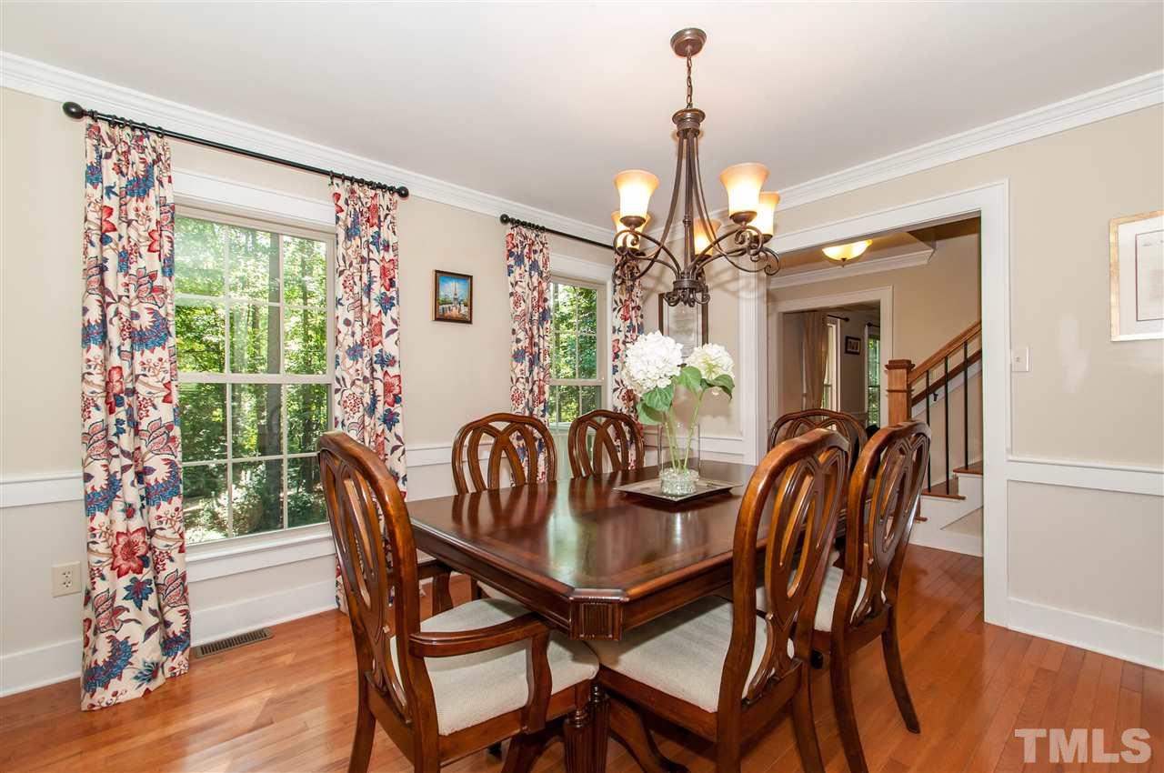 11905 Deer Run Raleigh, NC 27614 - Photo 9 of 25 a dining room with furniture a chandelier and wooden floor