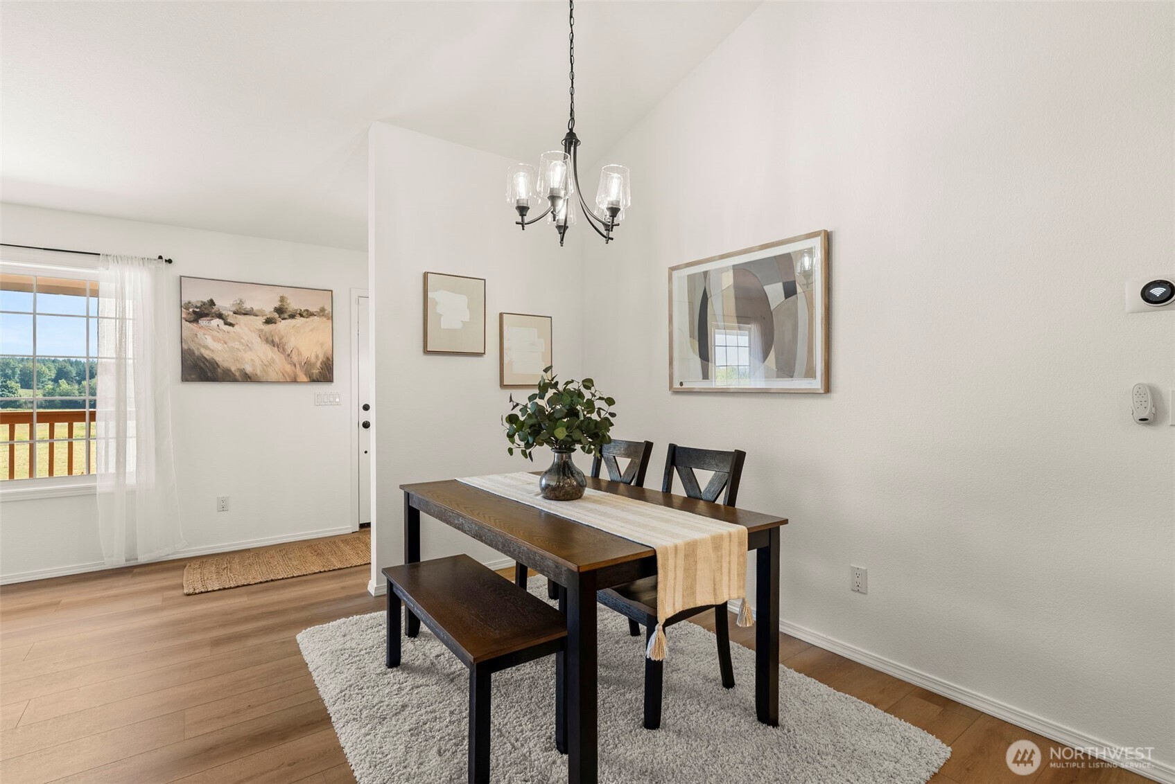12225 Case Road Southwest Olympia, WA 98512 - Photo 12 of 40 a dining room with wooden floor and a chandelier