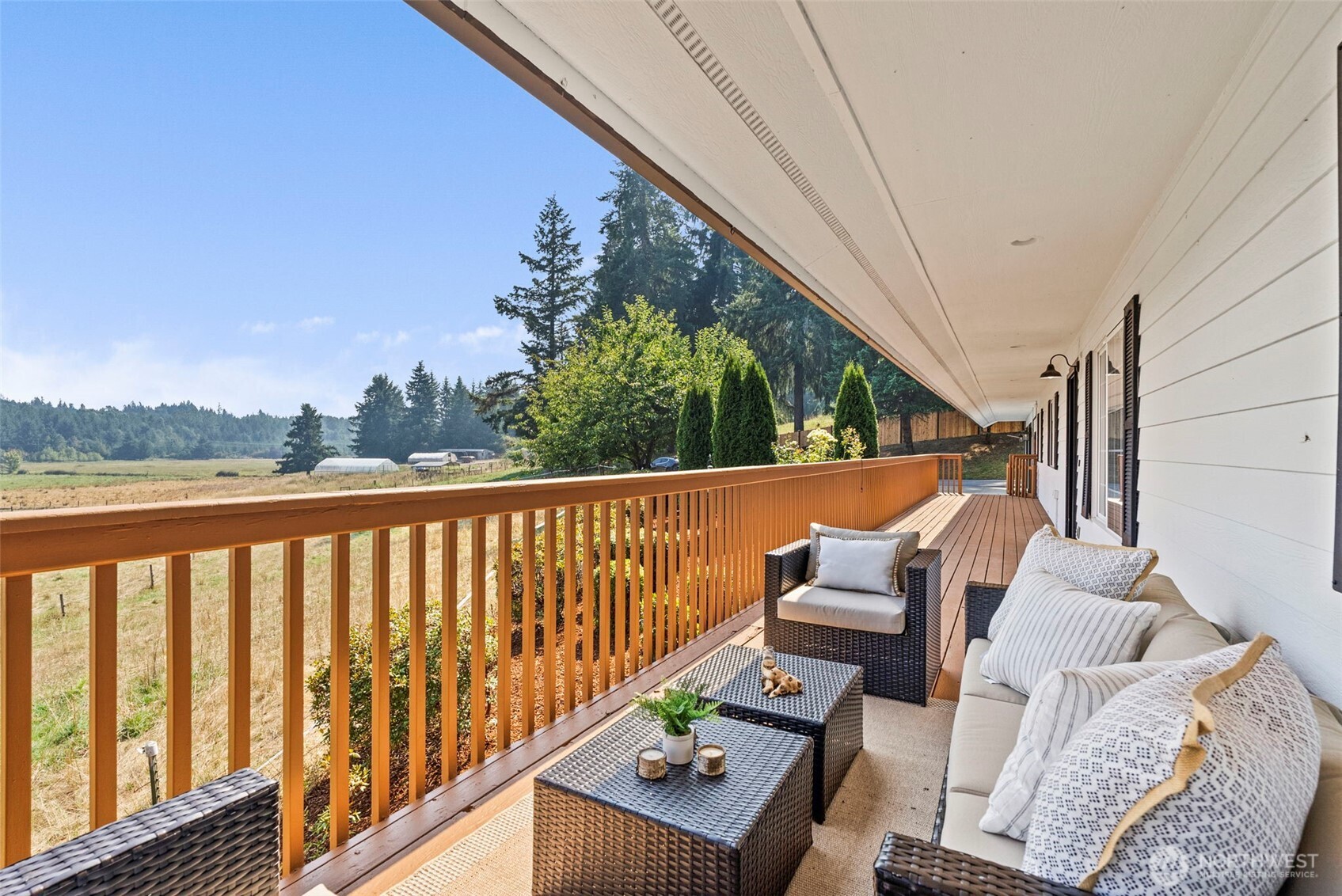 12225 Case Road Southwest Olympia, WA 98512 - Photo 7 of 40 a balcony with wooden floor outdoor seating and living room
