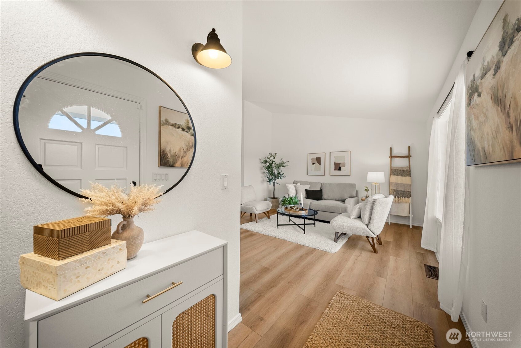 12225 Case Road Southwest Olympia, WA 98512 - Photo 9 of 40 a living room with furniture a mirror and a chandelier