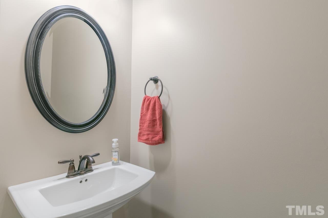 558 Fontana Drive Clayton, NC 27527 - Photo 19 of 41 a bathroom with a sink and a mirror